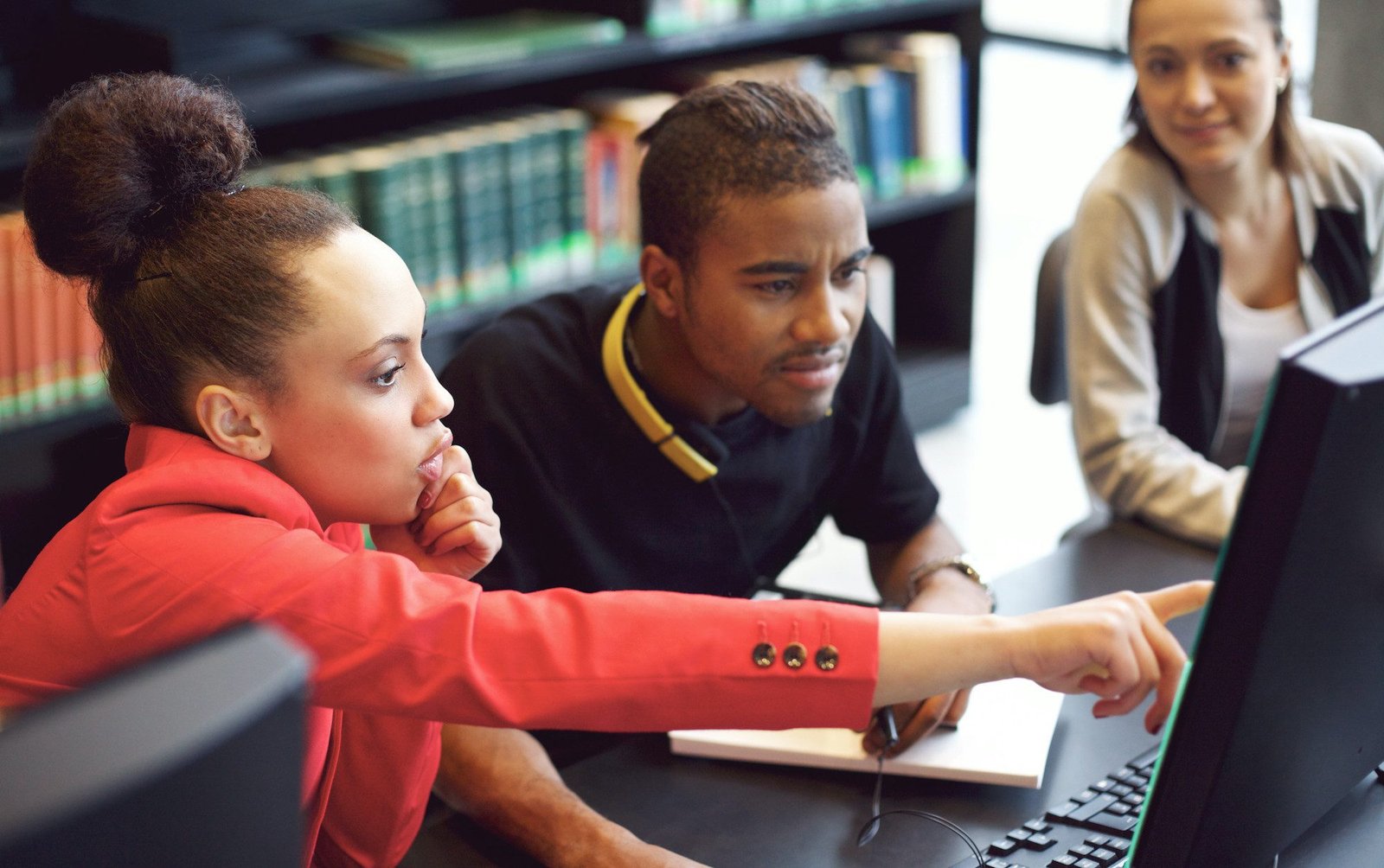 Three DP students working through a past paper together